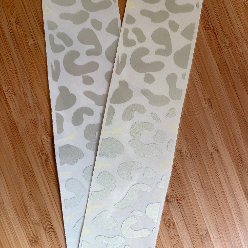 Close up picture of reflective wheelchair skins in silver leopard design. 