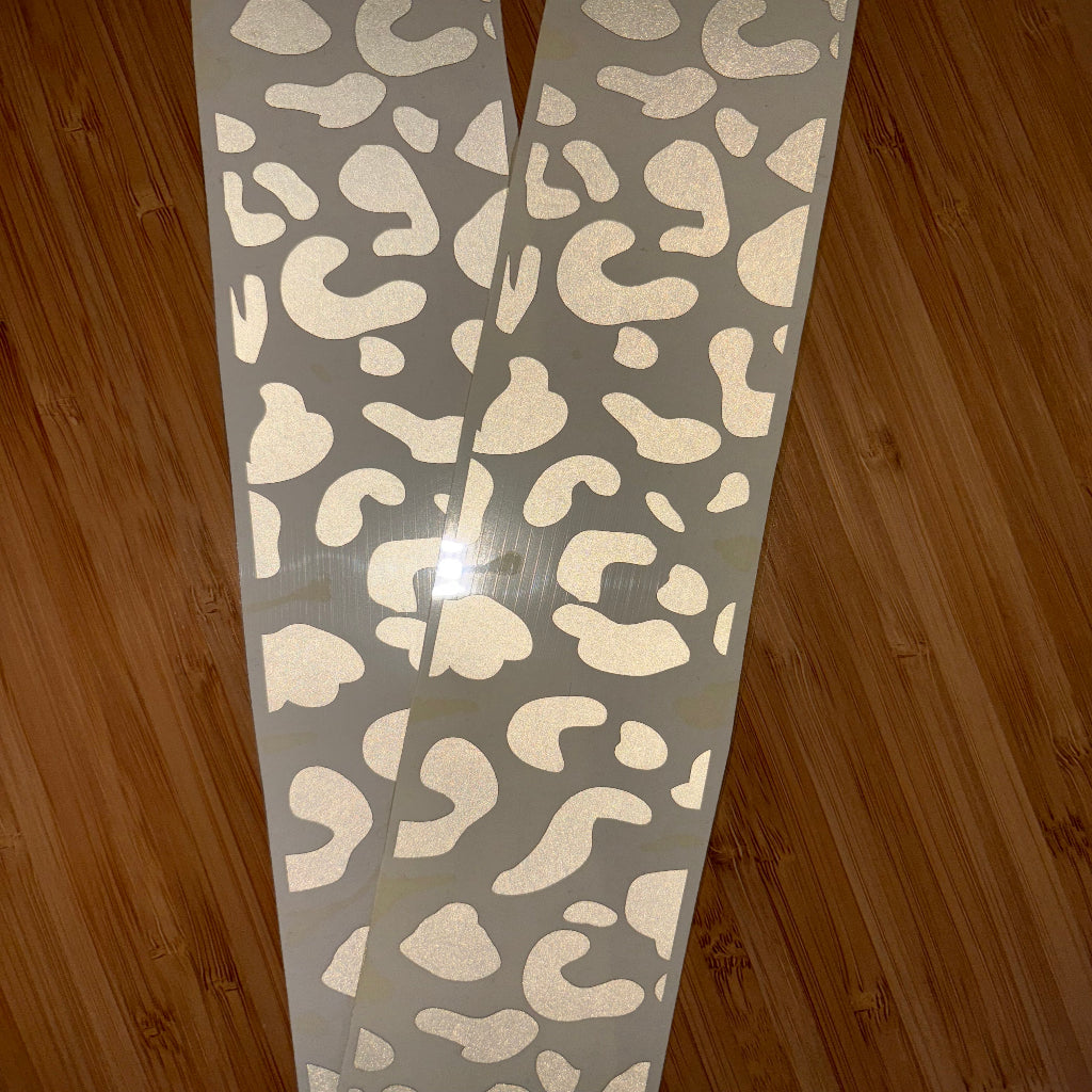 Close up picture of reflective wheelchair skins in silver leopard design. 