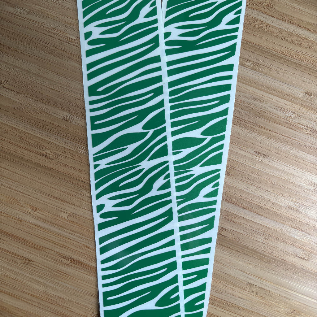 Close up picture of reflective wheelchair skins in green zebra design. 
